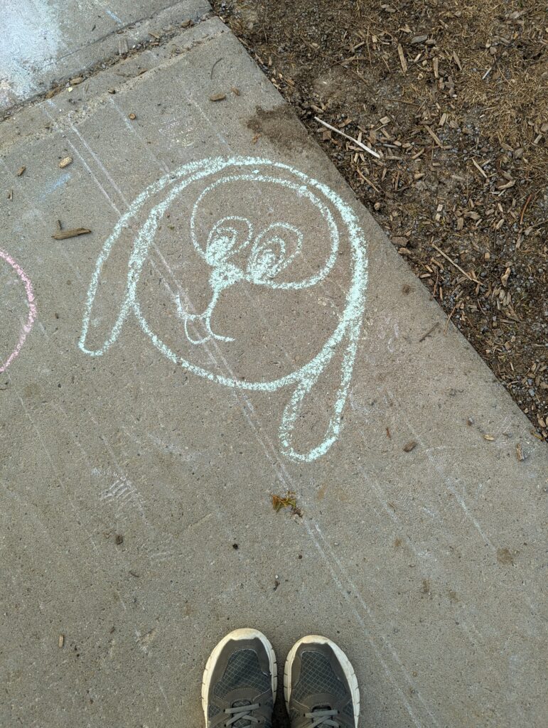 Chalk drawing of a cartoon puppy face